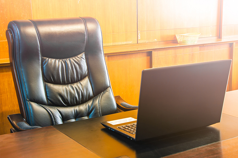 Vacancy for chairperson – photo of empty chair in a boardroom