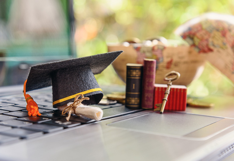 Well education Photo of a graduation cap, books, globe and laptop
