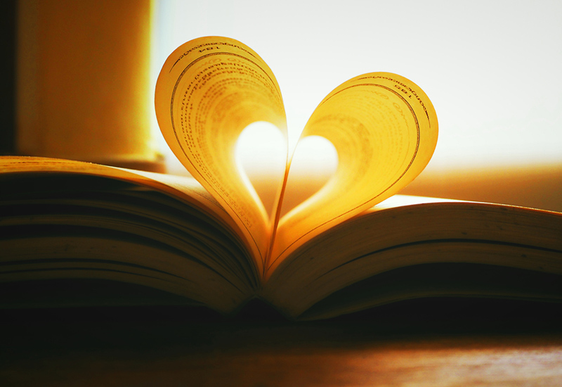 A book with two pages folded into a heart shape