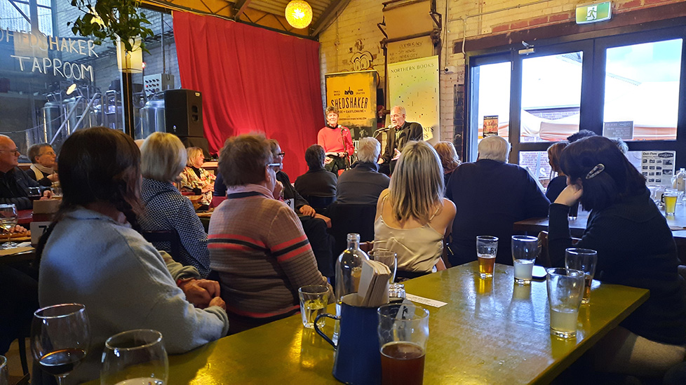 A seated crowd gathered at the Alex Miller event