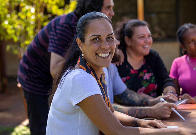 A woman smiles at the camera