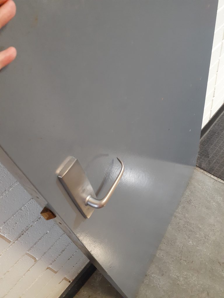 A door swung outwards featuring a lever handle.