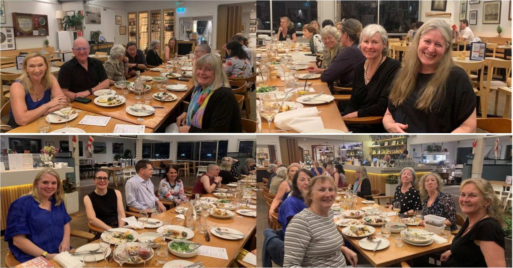 people sitting at a long dinner table