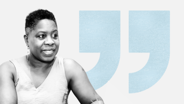 woman with short hair in front of blue quote marks